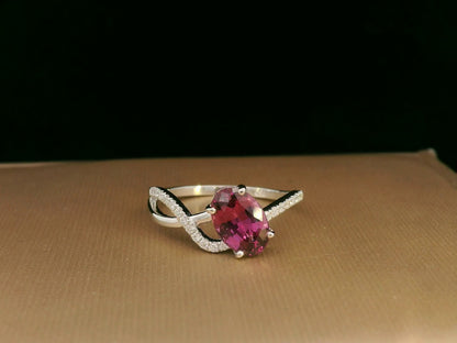 18K white gold Rhodolite garnet and diamond crossover ring with oval-cut center stone