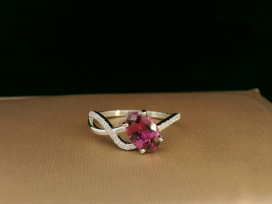 18K white gold Rhodolite garnet and diamond crossover ring with oval-cut center stone
