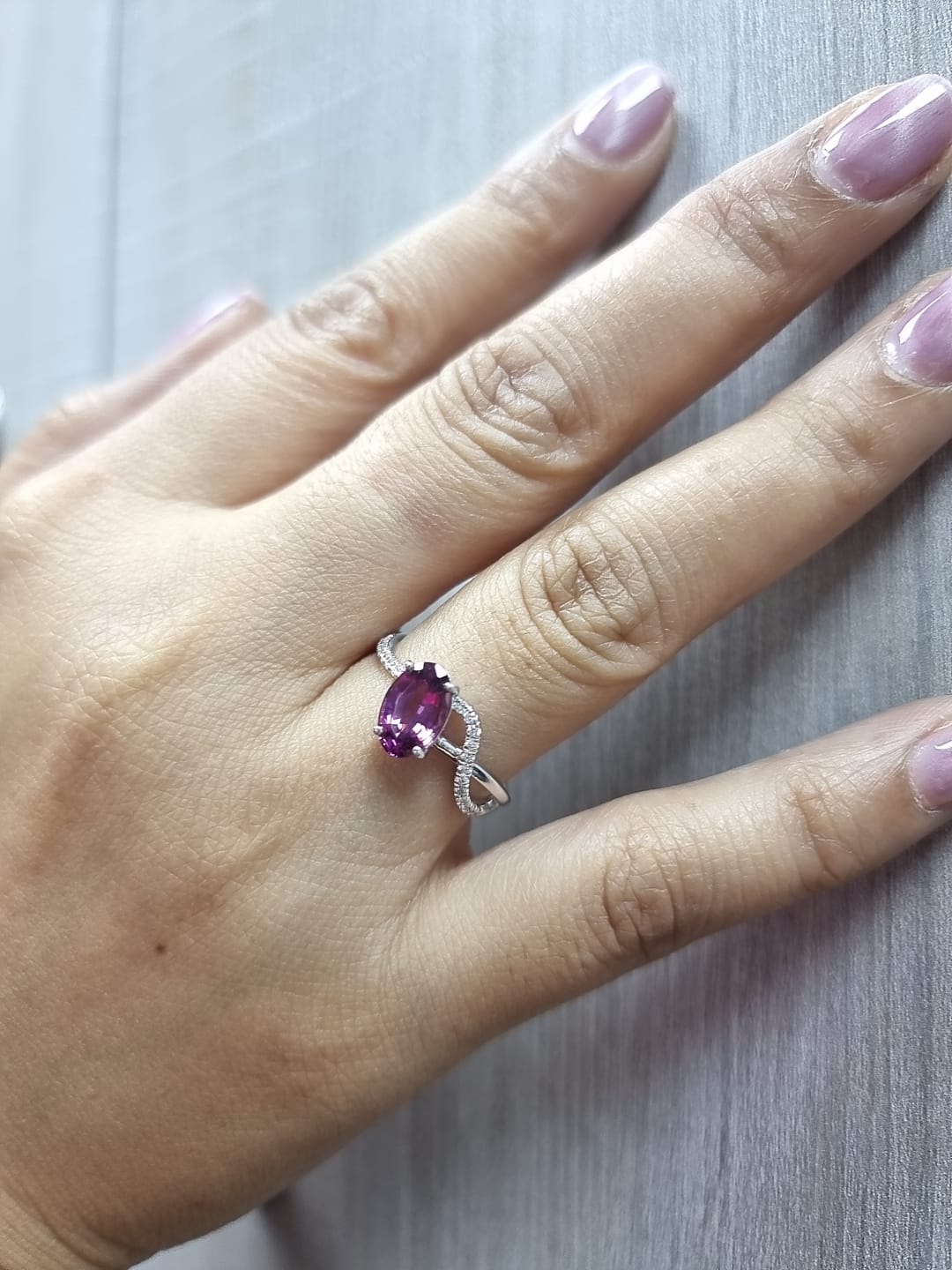 18K white gold Rhodolite garnet and diamond crossover ring with oval-cut center stone