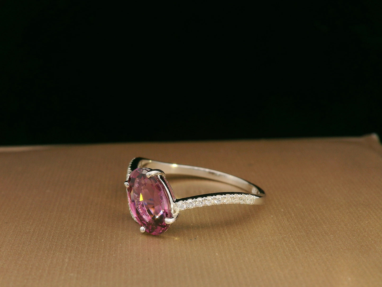 18K white gold Rhodolite garnet and diamond crossover ring with oval-cut center stone