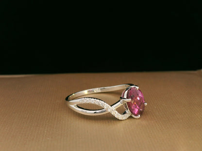 18K white gold Rhodolite garnet and diamond crossover ring with oval-cut center stone