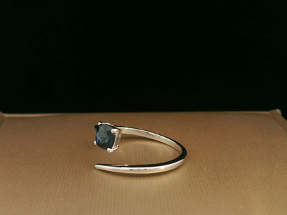 18K gold bypass ring with 0.49 carat cushion-cut blue sapphire, sleek modern design