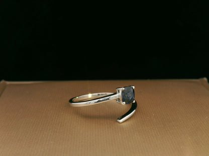 18K gold bypass ring with 0.49 carat cushion-cut blue sapphire, sleek modern design