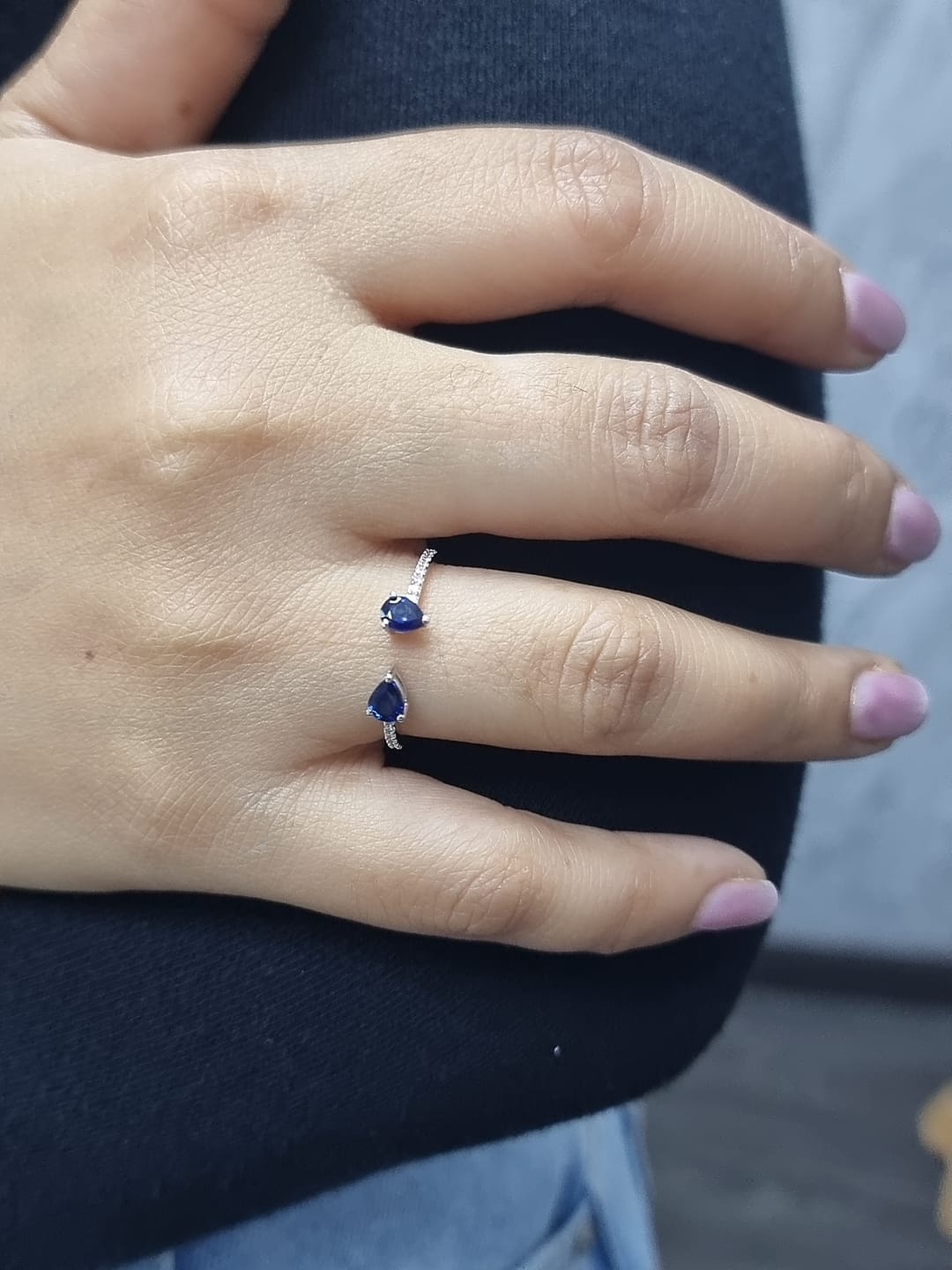 18K white gold open cuff ring with two teardrop-cut blue sapphires (0.70 carat) and 0.10 carat diamond pavé, modern minimalist design