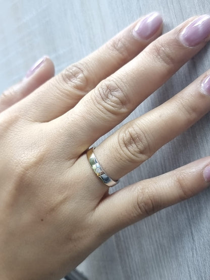 Unisex 18K two-tone wedding band with 0.03 carat bezel-set diamond, sleek modern flat profile