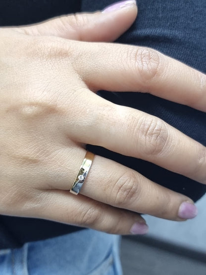 Unisex 18K two-tone wedding band with 0.03 carat bezel-set diamond, sleek modern flat profile