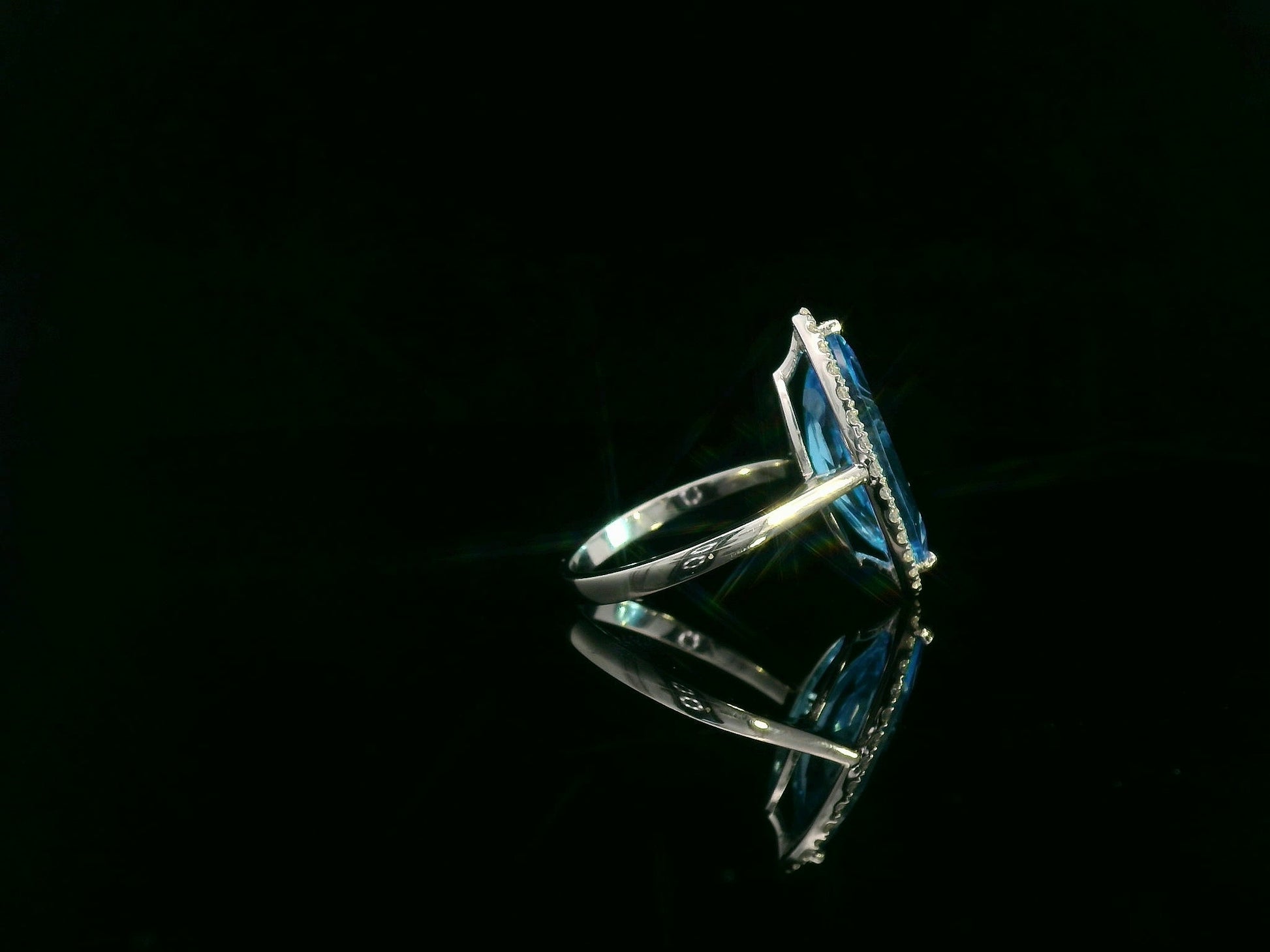 Marquise-cut blue topaz ring with diamond halo in 18K gold
