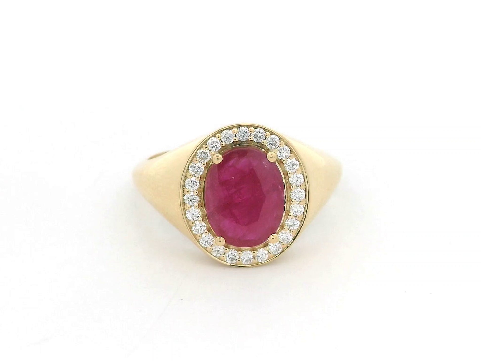 Men’s 18K yellow gold ring featuring 2.58 ct oval ruby with diamond halo and tapered band