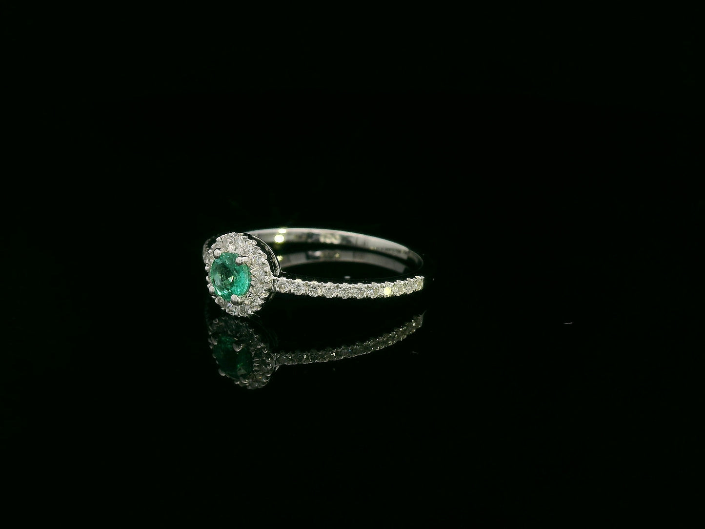 18K white gold emerald and diamond halo ring with 0.20ct round emerald and 0.28ct diamonds – Emirates Diamonds