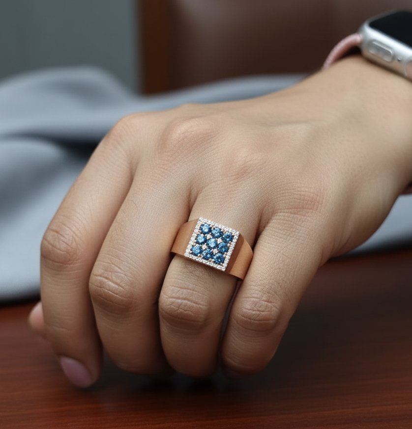 Men’s statement ring in 18K rose gold with nine round-cut blue diamonds (0.82 carat) in a square cluster, surrounded by 0.19 carat white diamonds – Emirates Diamonds