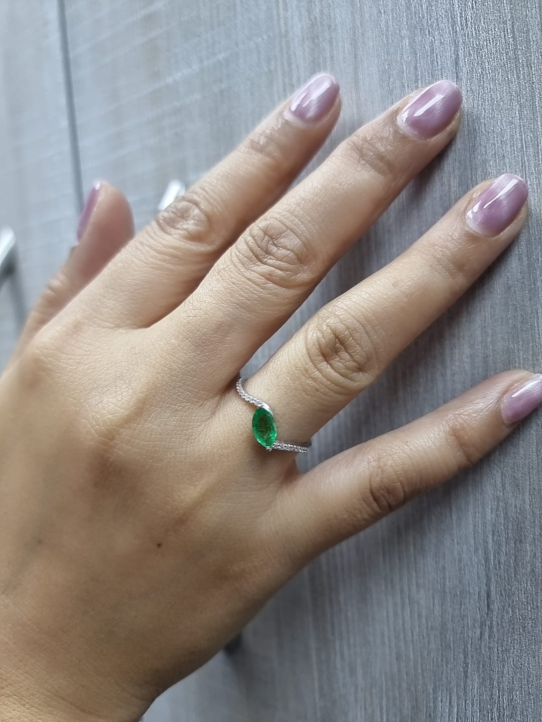 18K white gold emerald and diamond crossover ring with marquise-cut 0.65 carat emerald