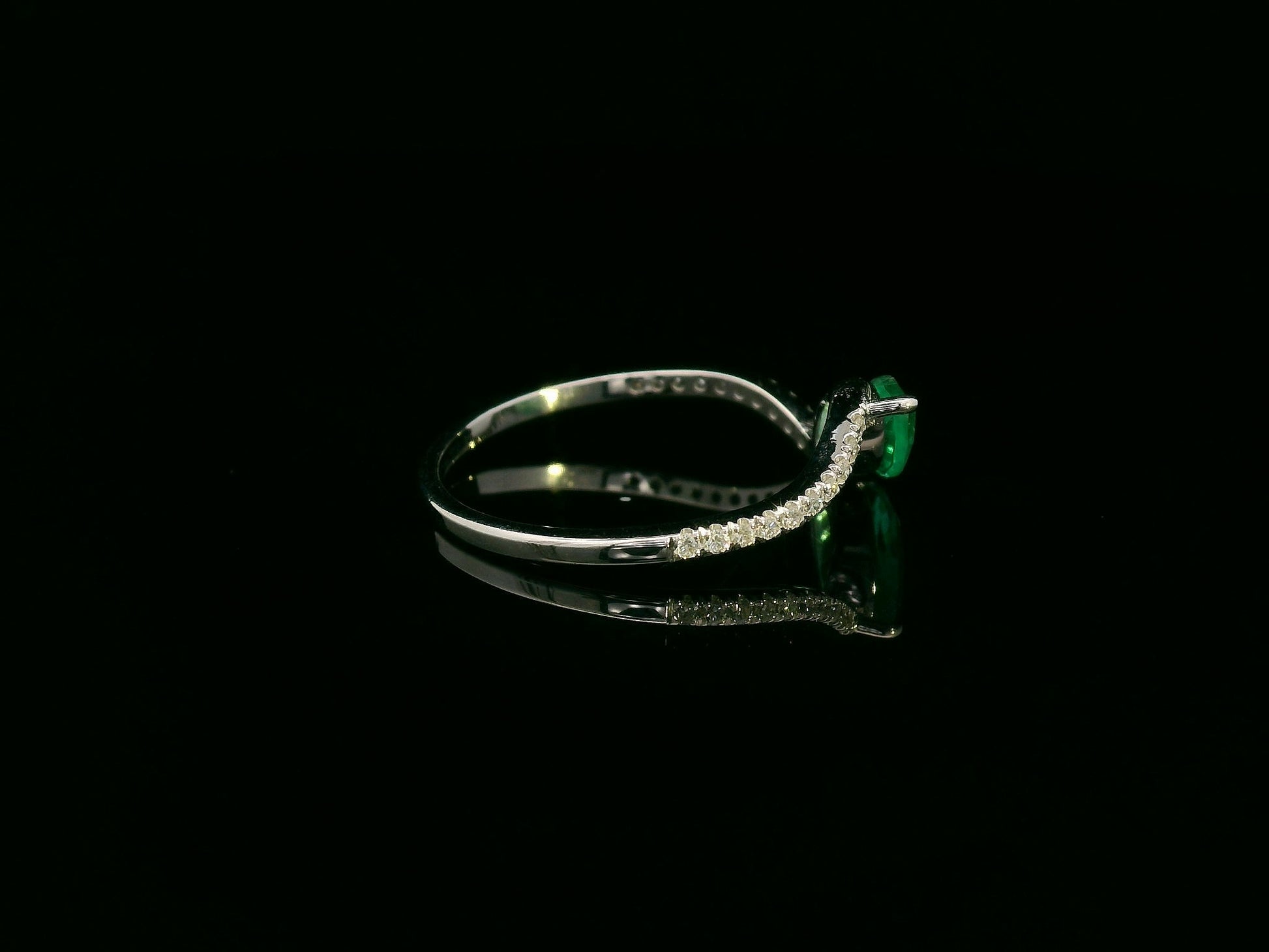 18K white gold emerald and diamond crossover ring with marquise-cut 0.65 carat emerald