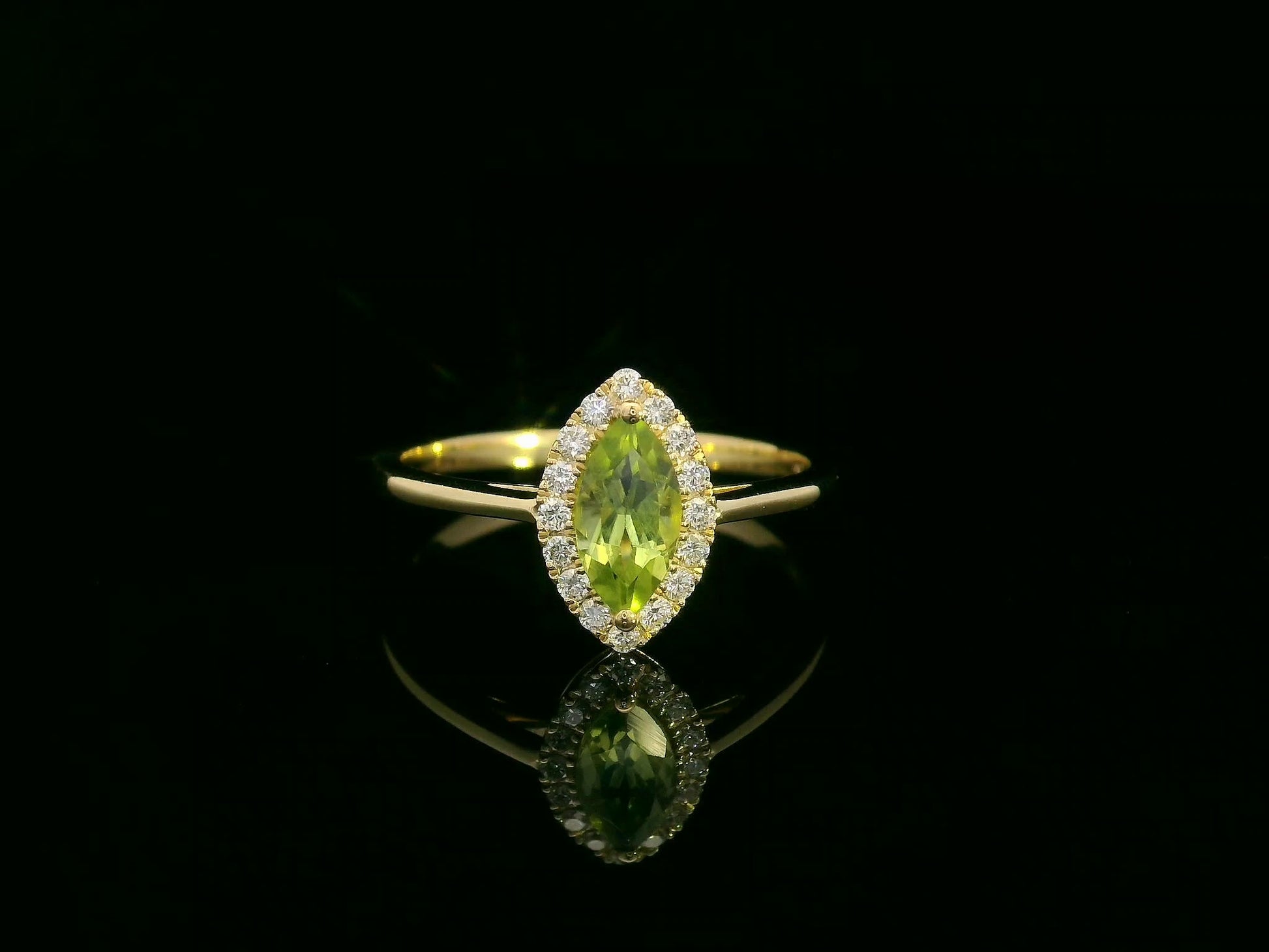 18k yellow gold ring featuring a 0.64ct marquise Peridot surrounded by a 0.15ct diamond halo