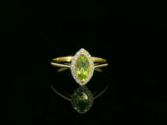 18k yellow gold ring featuring a 0.64ct marquise Peridot surrounded by a 0.15ct diamond halo