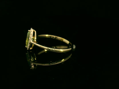 18k yellow gold ring featuring a 0.64ct marquise Peridot surrounded by a 0.15ct diamond halo