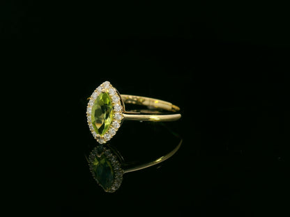 18k yellow gold ring featuring a 0.64ct marquise Peridot surrounded by a 0.15ct diamond halo
