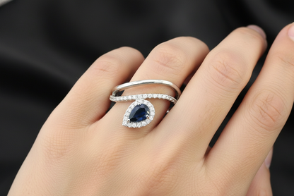 0.61 ct pear-cut blue sapphire and diamond halo ring in 18K white gold with double band design – Emirates Diamonds