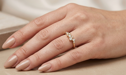 18K yellow gold diamond cluster ring with graduating round brilliant diamonds in an asymmetrical design