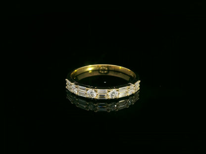 18K yellow gold half eternity diamond band featuring alternating baguette and round-cut diamonds 
