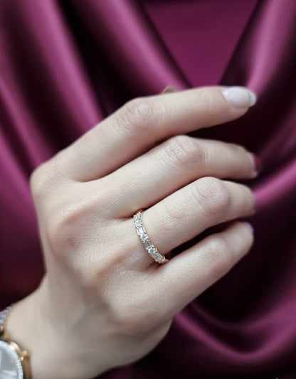 18K yellow gold half eternity diamond band featuring alternating baguette and round-cut diamonds 