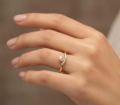 Minimalist diamond ring in 18K yellow gold with curved band and 0.07 carat total diamond weight, elegant everyday design by Emirates Diamonds