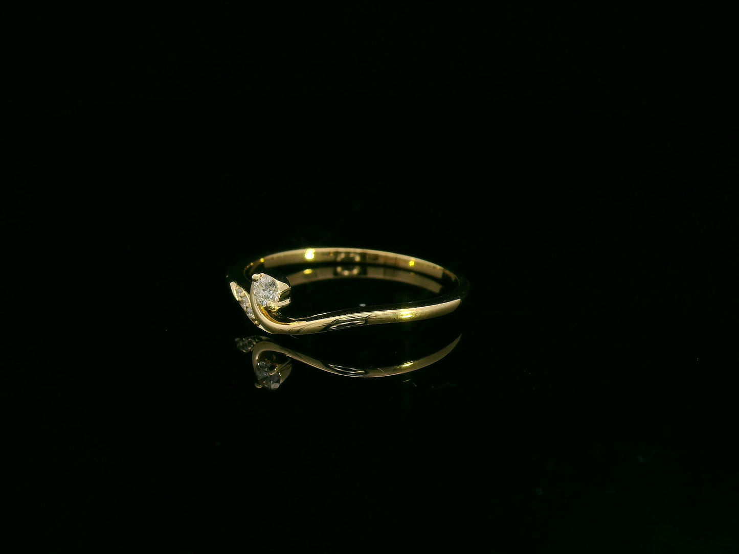 Minimalist diamond ring in 18K yellow gold with curved band and 0.07 carat total diamond weight, elegant everyday design by Emirates Diamonds