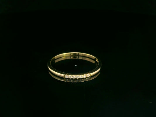 Dainty diamond stacking ring in 18K yellow gold by Emirates Diamonds