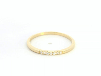 Dainty diamond stacking ring in 18K yellow gold by Emirates Diamonds