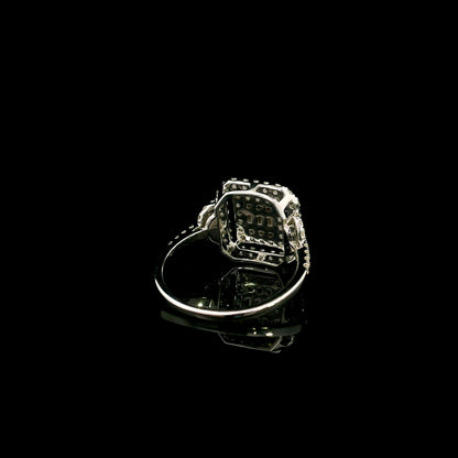 18K white gold statement ring featuring 0.09 carat natural baguette diamonds surrounded by 0.72 carat natural round brilliant diamonds in a geometric double halo design.