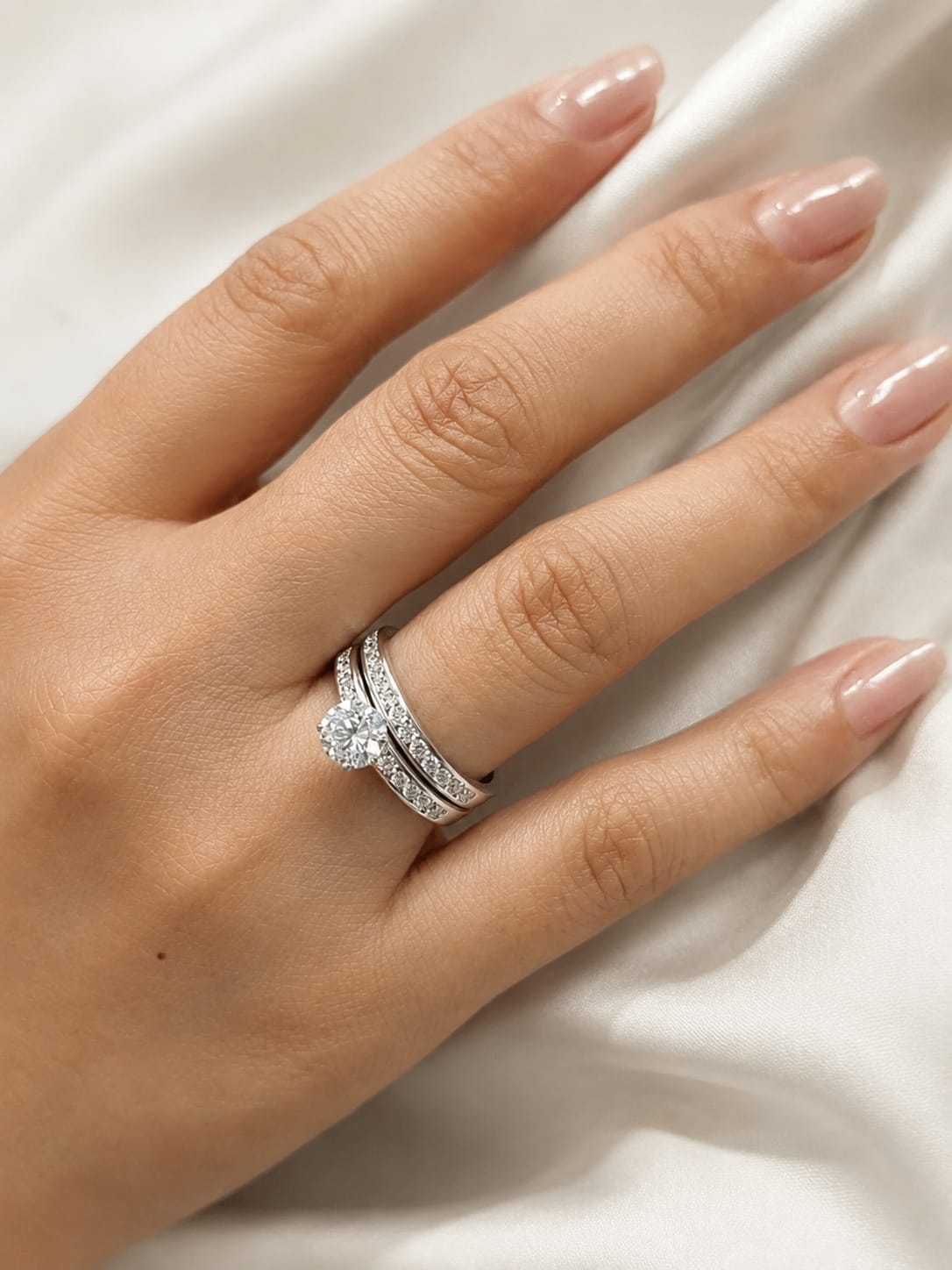 18K white gold diamond bridal set featuring a 1.01 carat GIA certified round diamond with matching diamond engagement ring and wedding band.