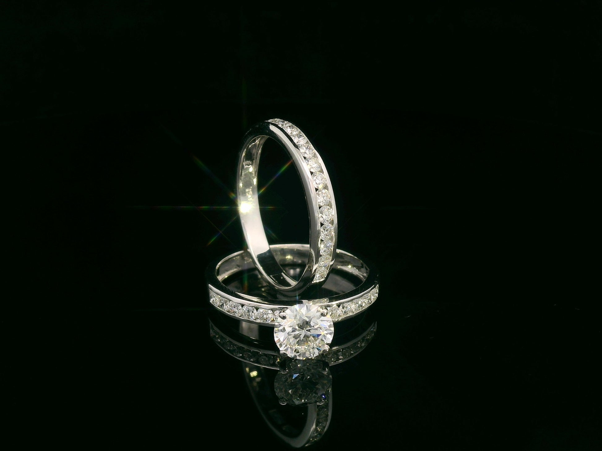 18K white gold bridal set featuring 1.01 carat D color GIA diamond with channel-set diamond bands
