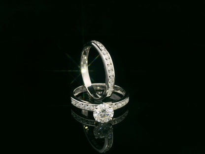 18K white gold bridal set featuring 1.01 carat D color GIA diamond with channel-set diamond bands