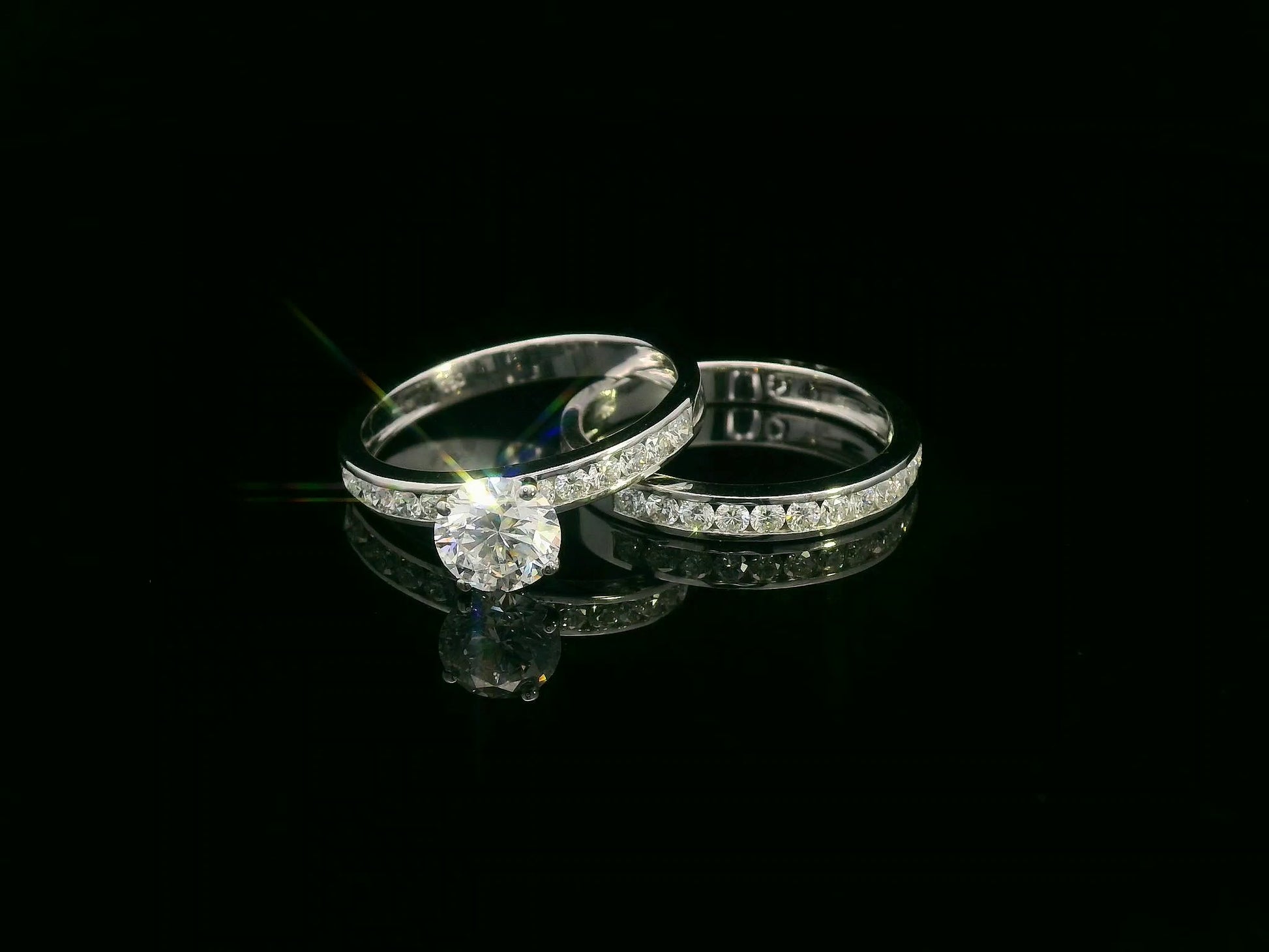18K white gold bridal set featuring 1.01 carat D color GIA diamond with channel-set diamond bands