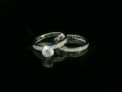 18K white gold bridal set featuring 1.01 carat D color GIA diamond with channel-set diamond bands