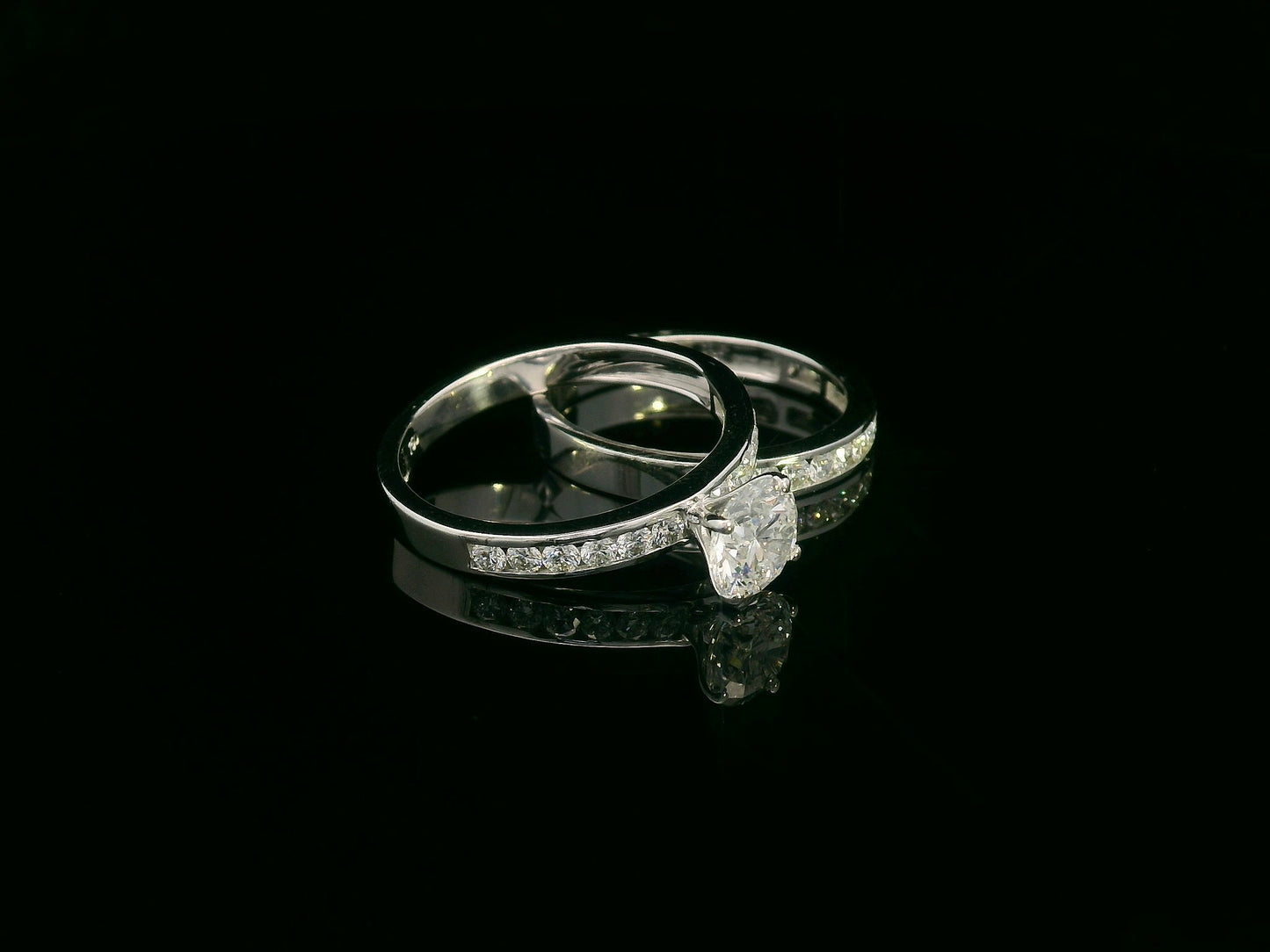 18K white gold bridal set featuring 1.01 carat D color GIA diamond with channel-set diamond bands