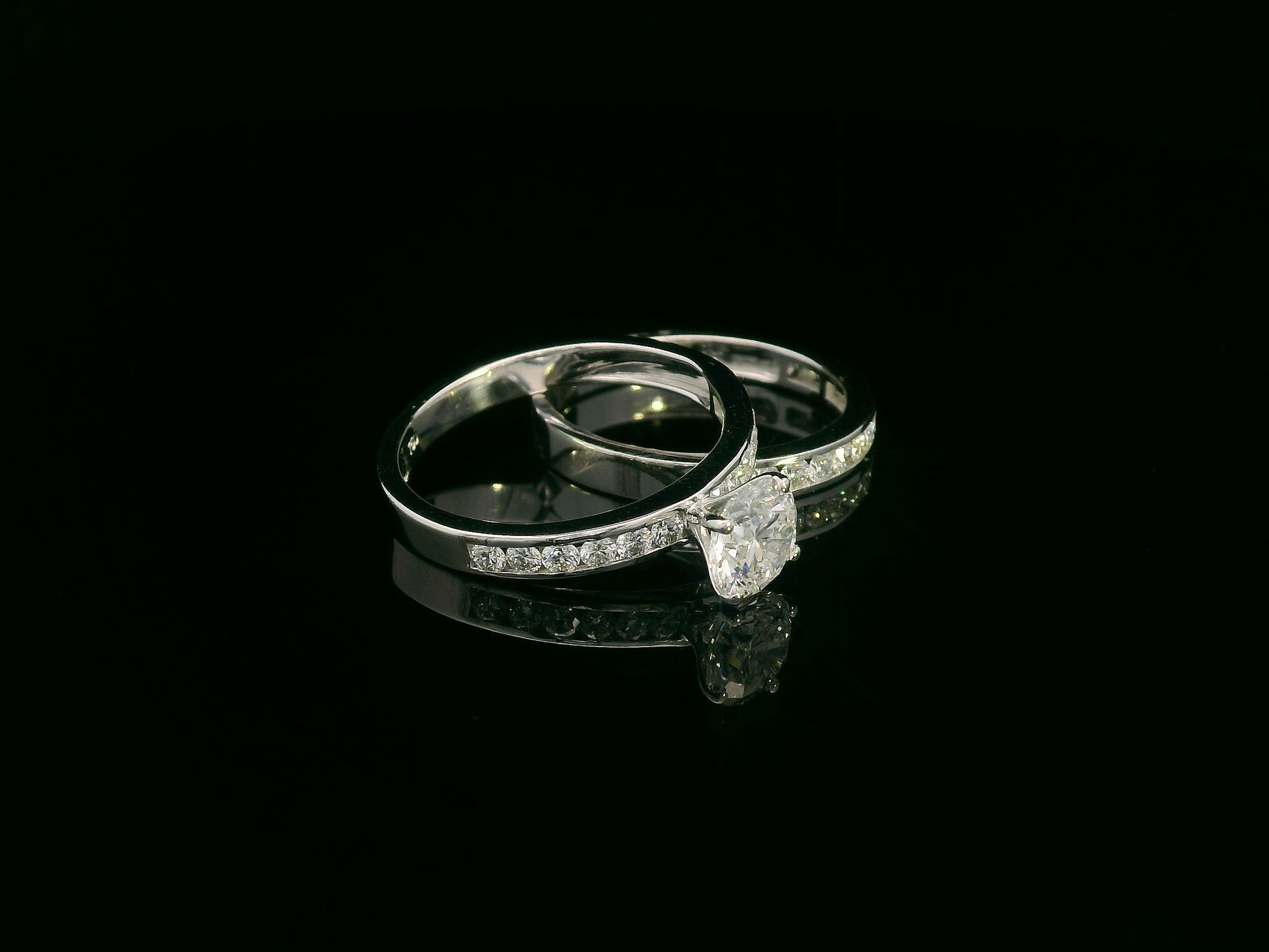 18K white gold bridal set featuring 1.01 carat D color GIA diamond with channel-set diamond bands