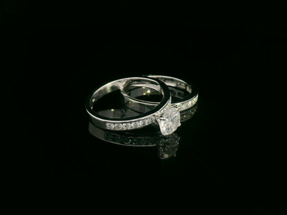 18K white gold bridal set featuring 1.01 carat D color GIA diamond with channel-set diamond bands
