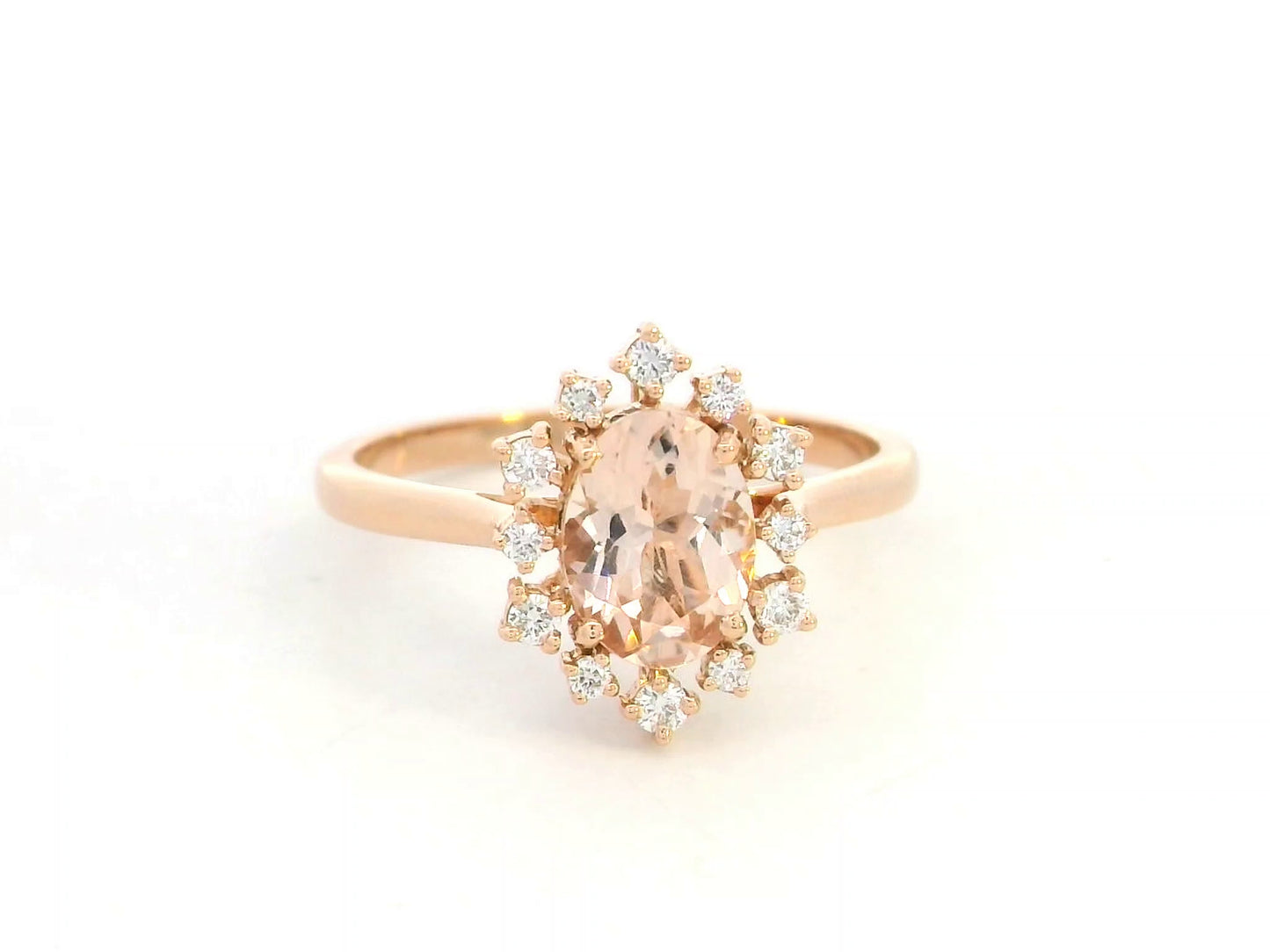 Oval-cut morganite and diamond ring in 18K rose gold, featuring a 1.03 carat morganite with a unique sunburst diamond halo, vintage Art Deco design by Emirates Diamonds