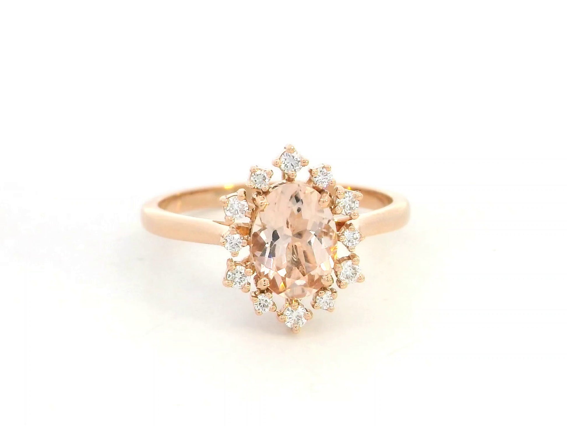 Oval-cut morganite and diamond ring in 18K rose gold, featuring a 1.03 carat morganite with a unique sunburst diamond halo, vintage Art Deco design by Emirates Diamonds