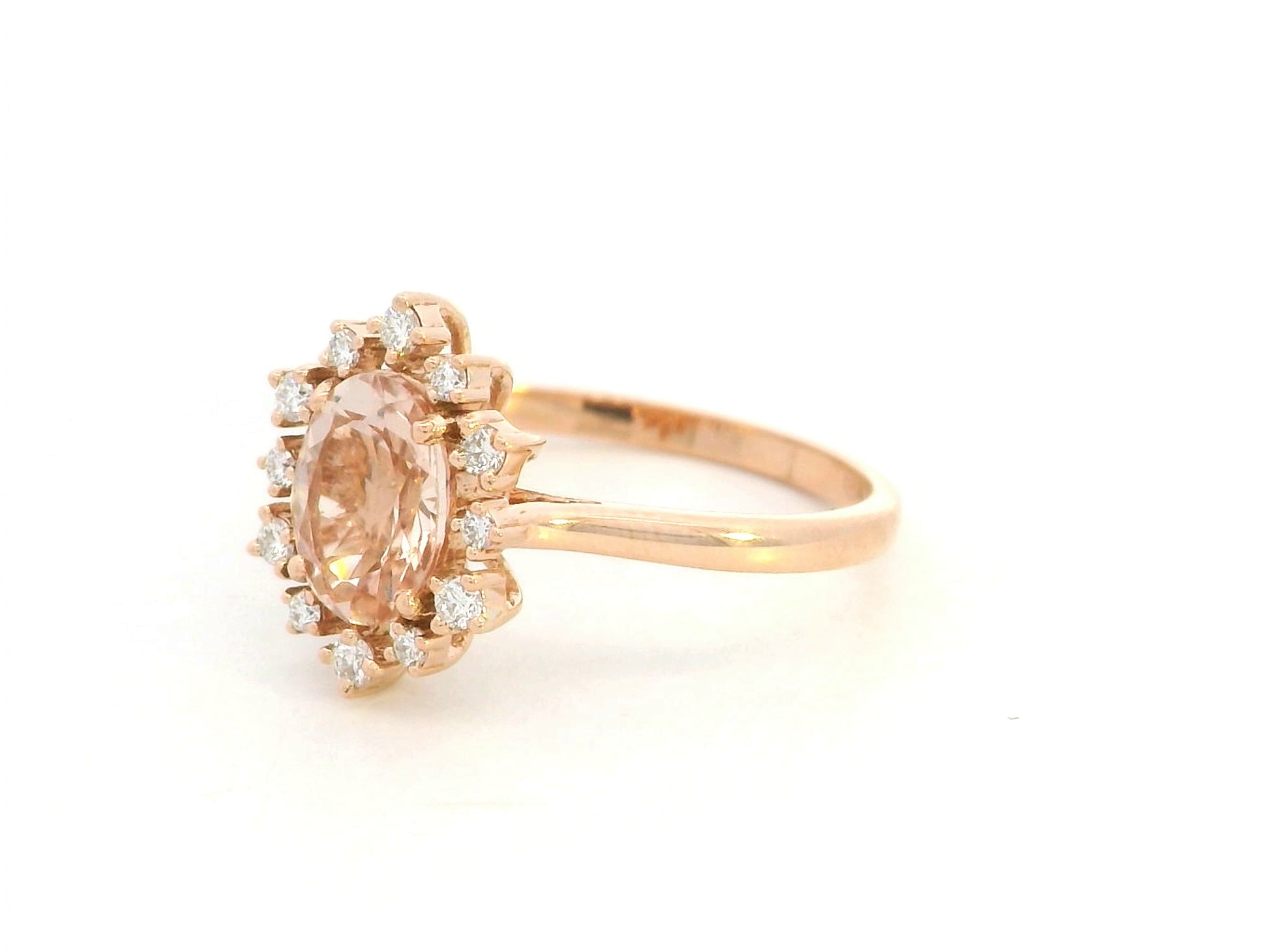 Oval-cut morganite and diamond ring in 18K rose gold, featuring a 1.03 carat morganite with a unique sunburst diamond halo, vintage Art Deco design by Emirates Diamonds