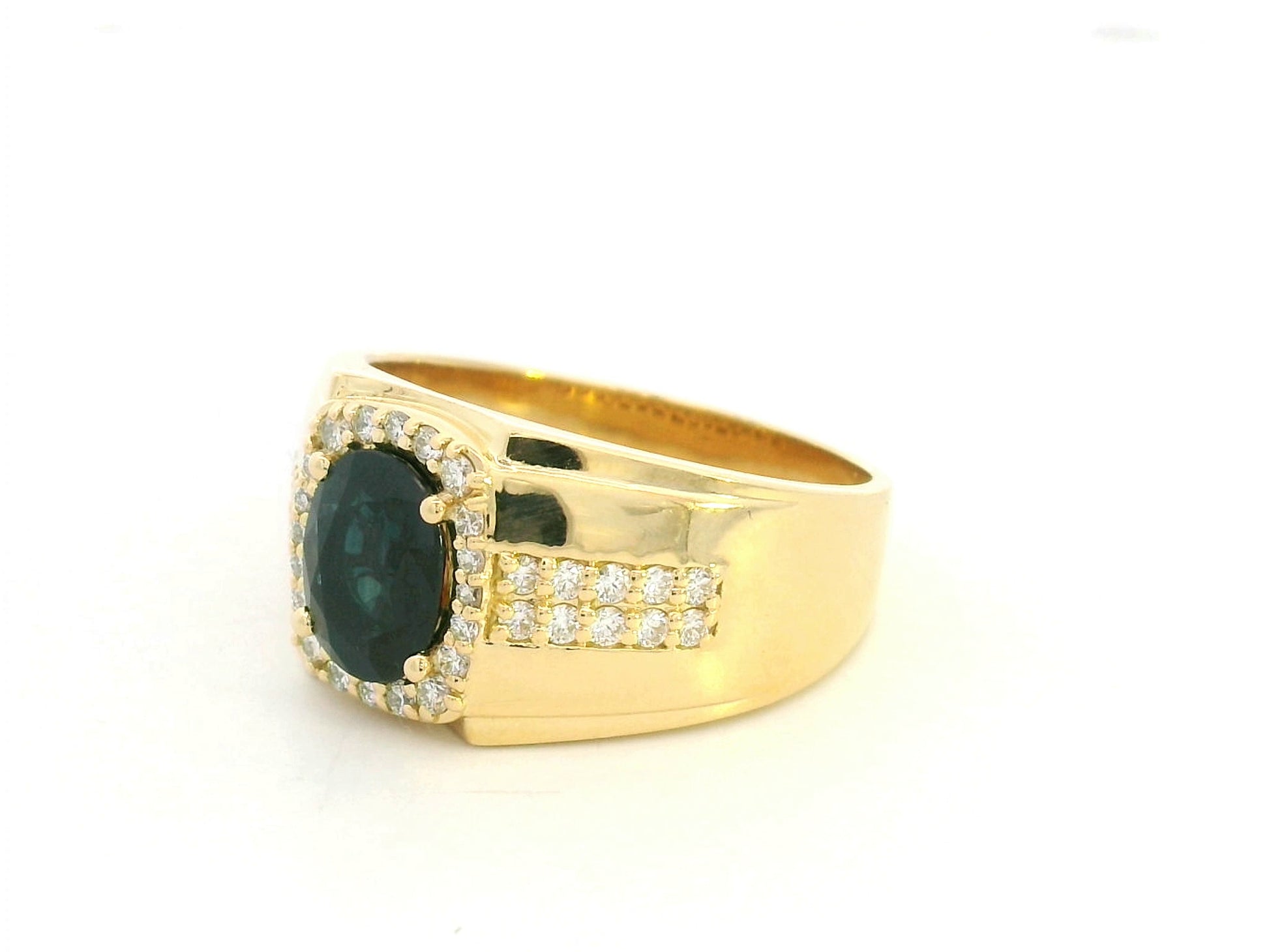 Men’s blue sapphire and diamond ring in 18K yellow gold featuring a 1.93 carat oval sapphire with halo and pavé-set side diamonds – Emirates Diamonds