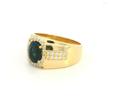 Men’s blue sapphire and diamond ring in 18K yellow gold featuring a 1.93 carat oval sapphire with halo and pavé-set side diamonds – Emirates Diamonds