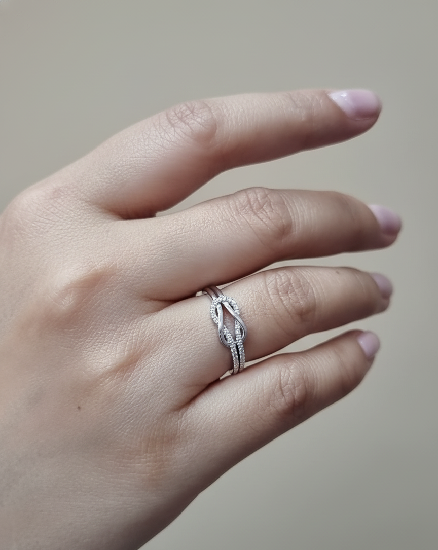 18K white gold diamond knot ring with pavé-set diamonds – minimalist symbolic jewelry by Emirates Diamonds