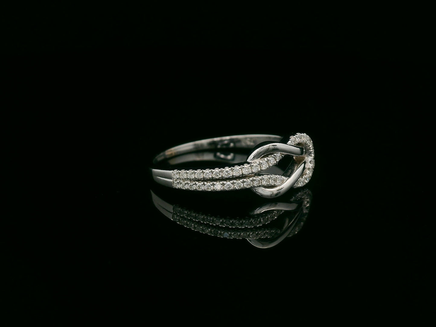 18K white gold diamond knot ring with pavé-set diamonds – minimalist symbolic jewelry by Emirates Diamonds