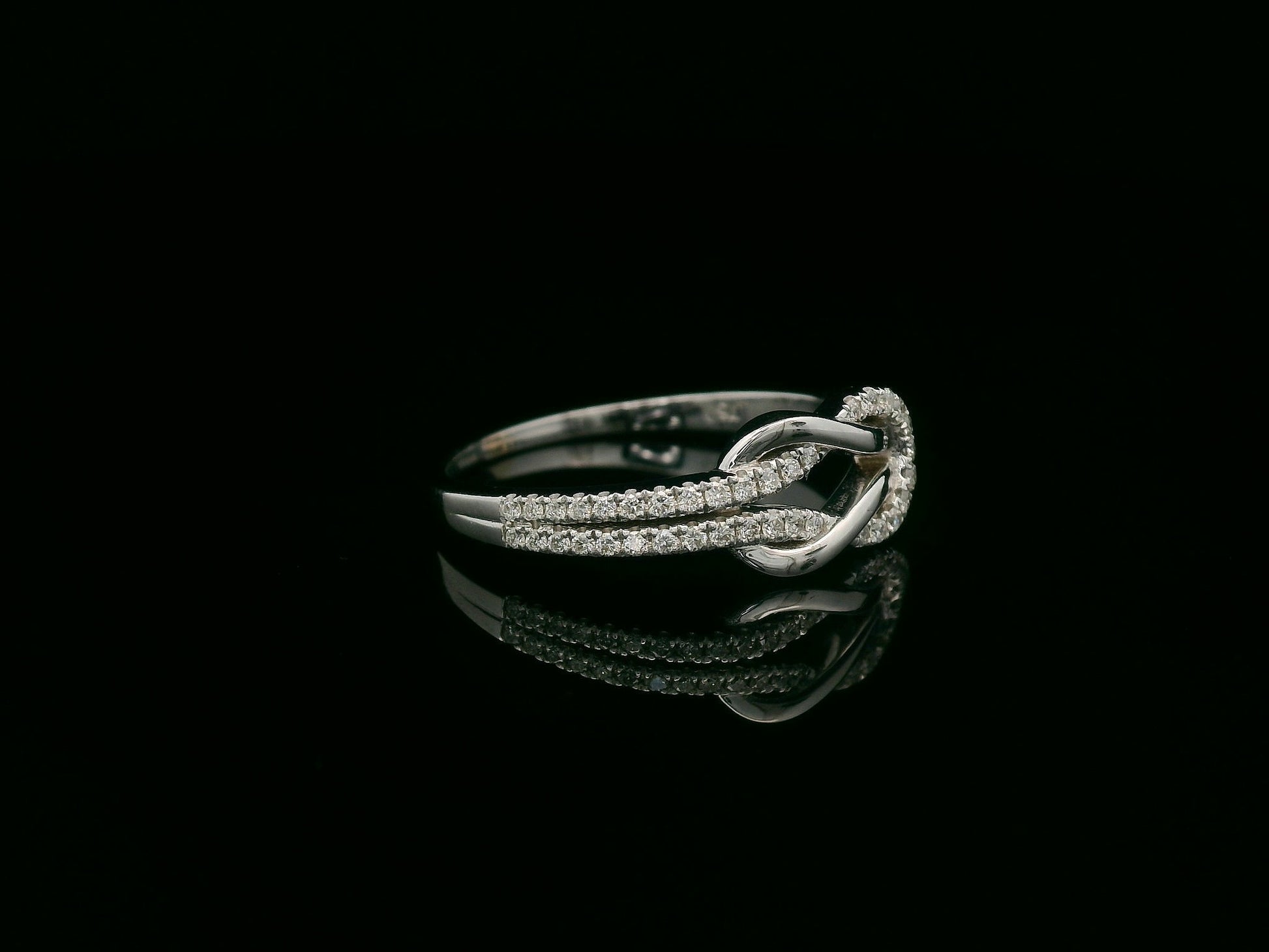 18K white gold diamond knot ring with pavé-set diamonds – minimalist symbolic jewelry by Emirates Diamonds