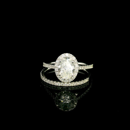 Oval diamond bridal set in 18K white gold with GIA certified natural diamond halo engagement ring and matching diamond wedding band