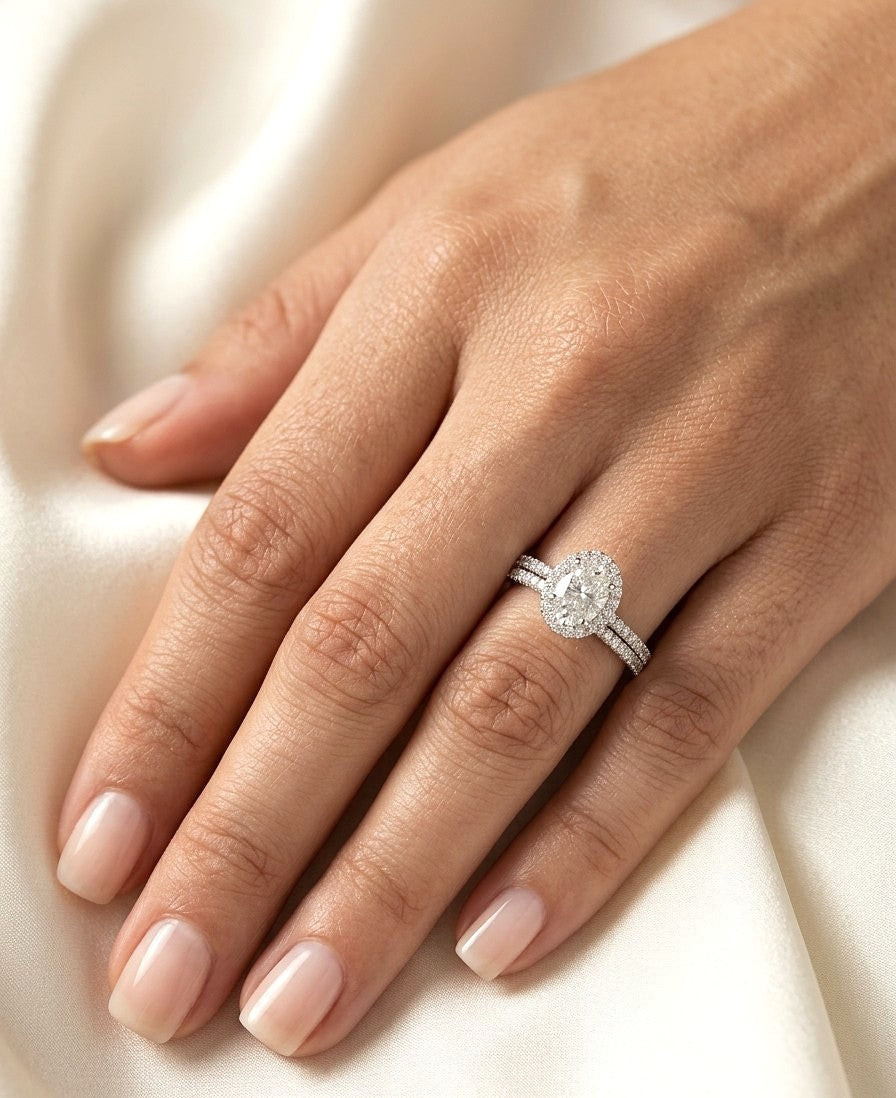 Oval diamond bridal set in 18K white gold with GIA certified natural diamond halo engagement ring and matching diamond wedding band