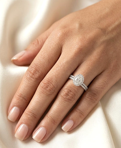 Oval diamond bridal set in 18K white gold with GIA certified natural diamond halo engagement ring and matching diamond wedding band