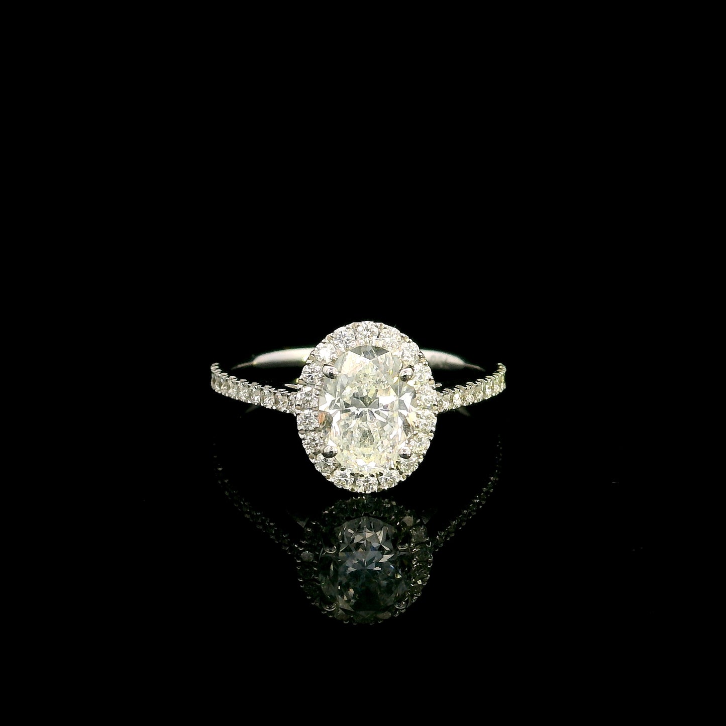 Oval diamond bridal set in 18K white gold with GIA certified natural diamond halo engagement ring and matching diamond wedding band