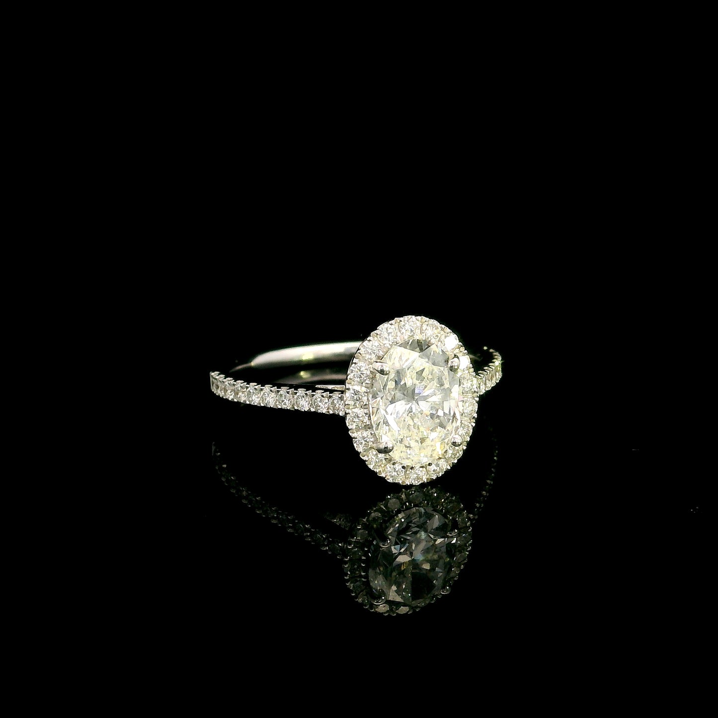 Oval diamond bridal set in 18K white gold with GIA certified natural diamond halo engagement ring and matching diamond wedding band